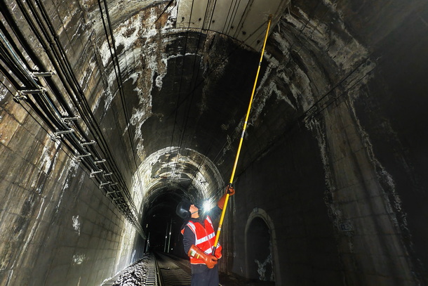 圖為供電維修工正在進行隧道打冰作業